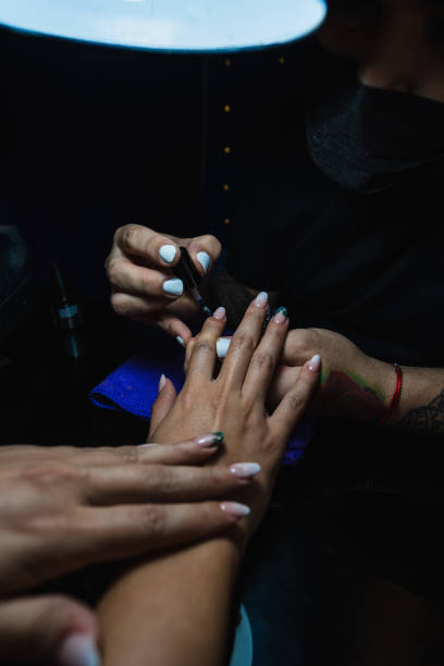 istock Manicurist man working in a woman's hands 1308490513