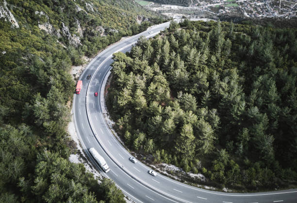 istock Red color challenge ,Vehicles going on mountain winding road roads 1308492358