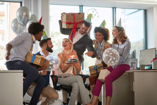 istock Happy people celebrating birthday together at work. 1308493645