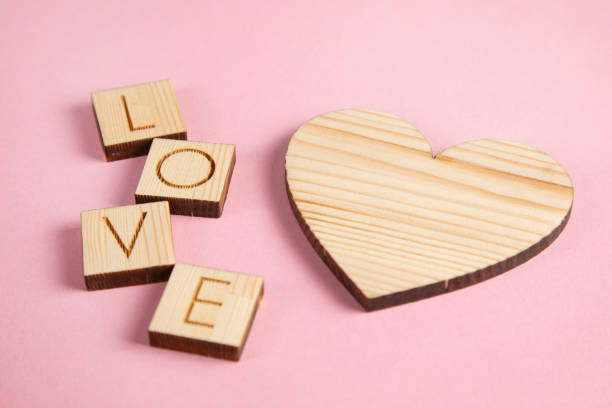 istock wooden heart and love text 1308493671