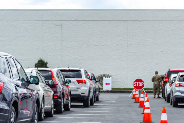 Cars In Line For Covid Vaccination March 22, 2021 - Clarksville, Tennessee, U.S.: Cars wait in line for a Covid 19 vaccination at the Governors Square Mall outside of what was formerly a Sears department store. tennessee road sign stock pictures, royalty-free photos & images