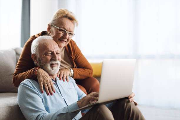 istock Happy mature couple relaxing  at home and using laptop 1308495042