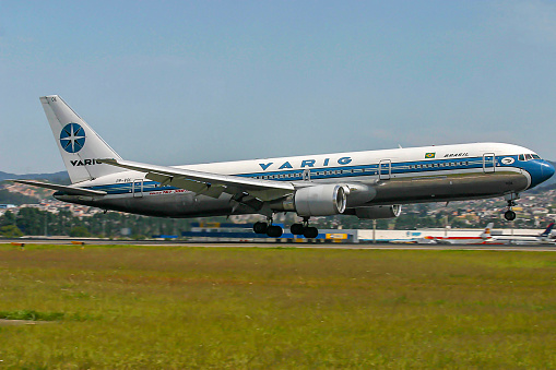 A white Boeing 767 cargo lands at Portland International Airport.