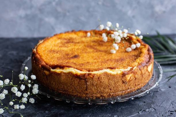 istock Cheesecake on a plate decorated with white flowers. 1308496157