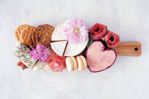 Mother's Day theme charcuterie board against a white marble background