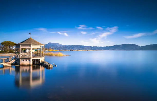 Gazebo pier or jetty and lake at sunrise. Torre del Lago Puccini, Versilia, Massaciuccoli lake, Tuscany, Italy, Europe