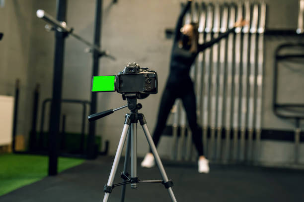 istock fitness instructor with a mask on her face doing online instruction 1308498973