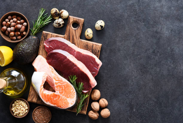 Fish, meat and vegetables on a concrete background. Foods with vitamin b content. Balanced diet. The keto diet. stock photo