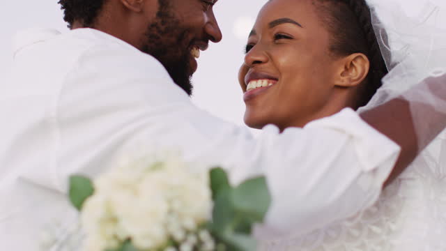 African american couple in love getting married, smiling and dancing on the beach