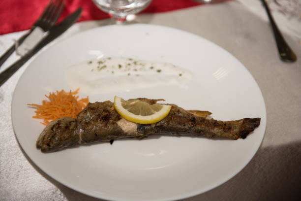 istock fried trout and lemon on a plate 1308502692