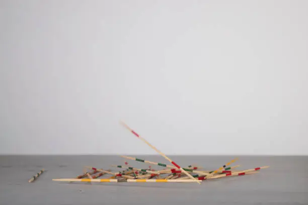 mikado game sticks, fallen down on a wooden board, motion blur