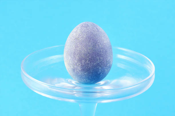 istock A blue Easter egg on a blue background in a glass vase . Easter Concept 1308506704
