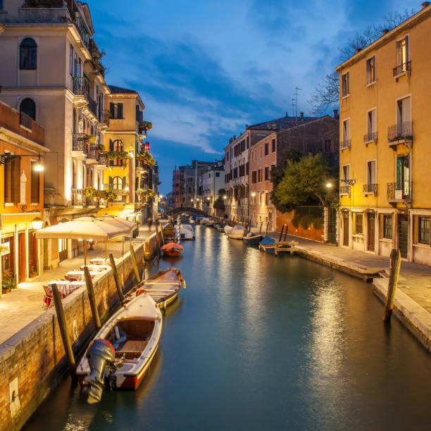 istock night Venice, channel with boats 1308511933