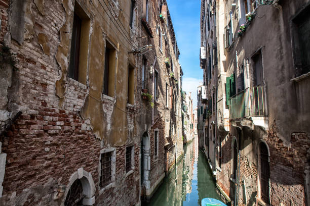 istock old Venice, channel with boats 1308511946