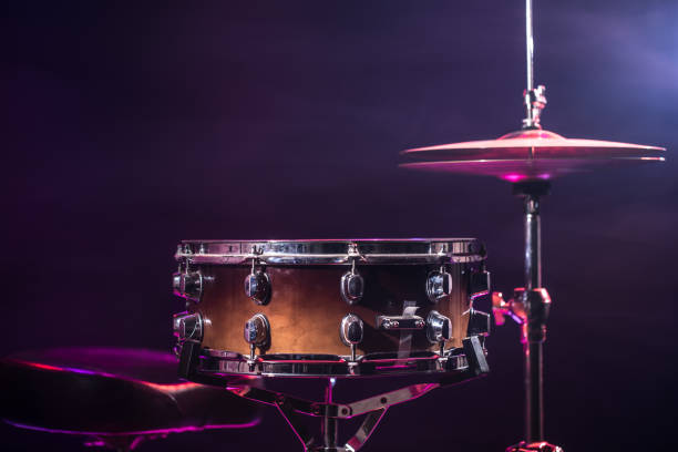 istock Drums and drum set. Beautiful blue and red background, with rays of light. Beautiful special effects of smoke and lighting. Musical instrument. Close-up photo. 1308514042