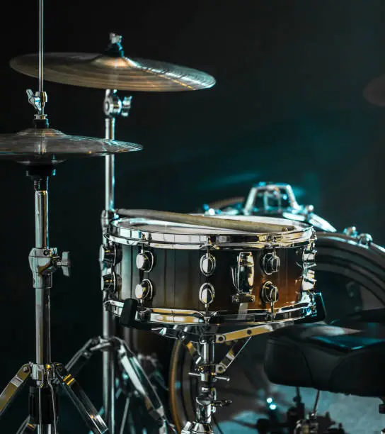 Photo of musical instruments drum kit, flash of light, a beautiful light in the background with copy space