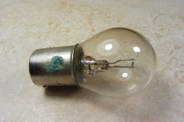 istock An old bulb on a ligt background. Retro vintage style. 1308516325
