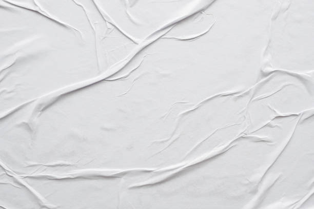 istock Blank white crumpled and creased paper poster texture background 1308519996