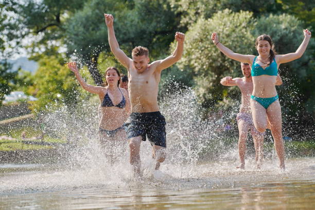 istock group of happy friends having fun on river 1308520255