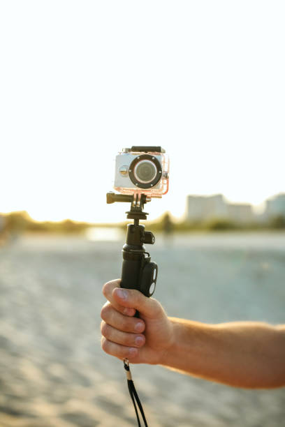 istock Young man filming with action camera at the desert 1308520329