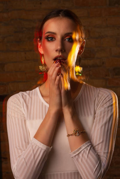 istock Wonderful girl with bright makeup with blurred lights 1308520330