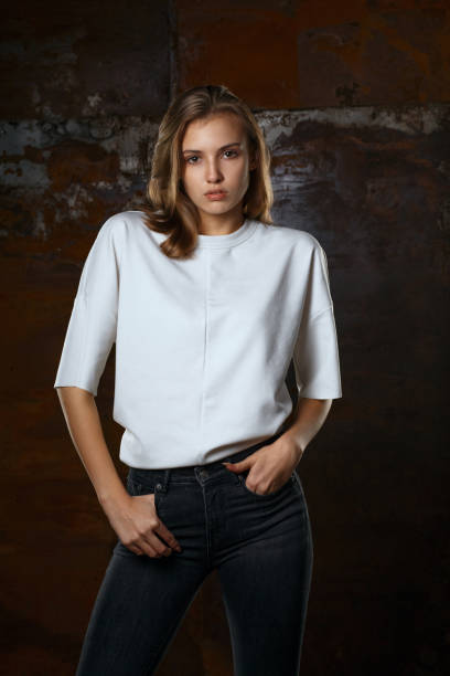 istock Trendy dressed adorable girl posing at brown wall 1308520342