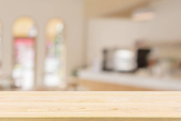 istock Empty wood table top with cafe restaurant interior blur background 1308520550