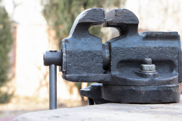 istock Old vise on a wooden bakground. Old instrument. 1308520790