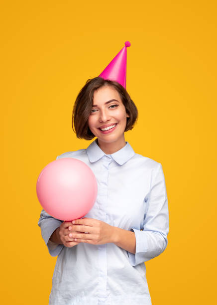 istock Happy woman with balloon during birthday celebration 1308520825