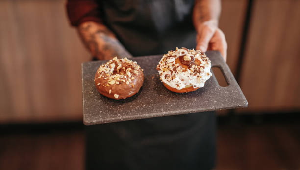 istock Waiter serving sweet pastry in cafe 1308520850