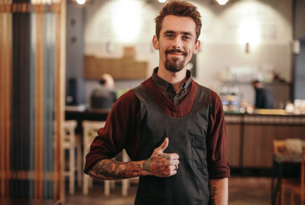 istock Male barista approving work in cafe 1308520900