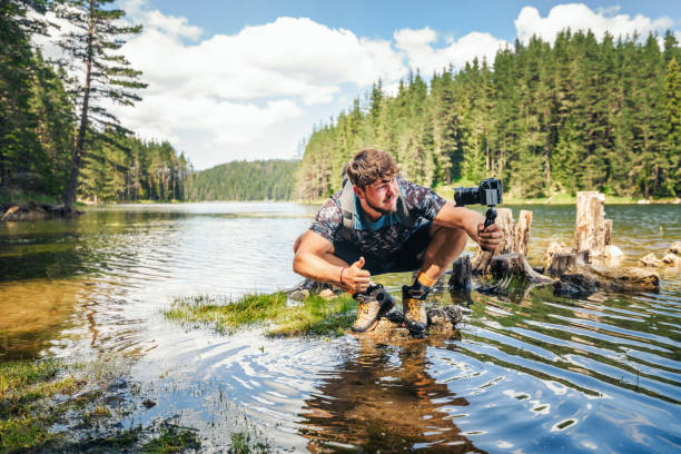 istock Young explorer photographing nature and vlogging. 1308520940