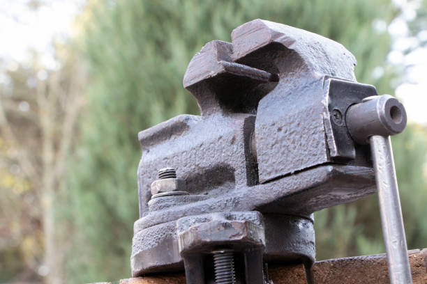 istock Old vise on a wooden bakground. Old instrument. 1308522077