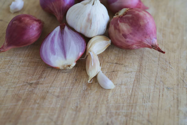 istock Onion and garlic for cooking on old wooden background 1308522367