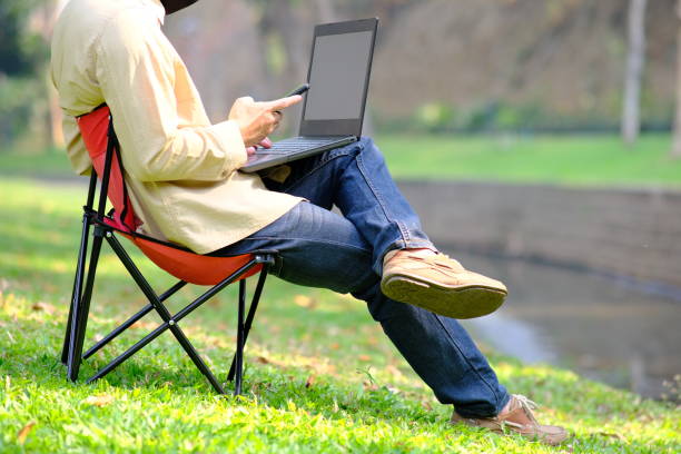 istock man using laptop computer in garden background and relaxing on holiday 1308524054