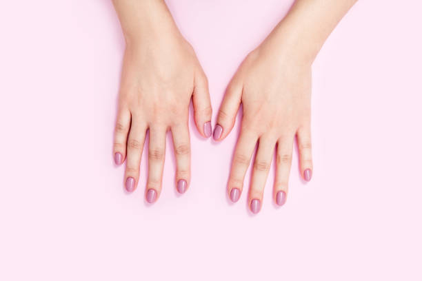 istock Beautiful female hands on a pink background. 1308525443