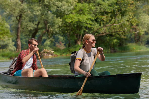 istock friends are canoeing in a wild river 1308529124