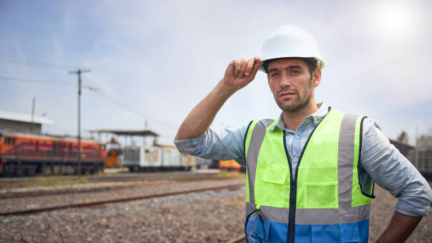istock Railway engineer wearing white helmet standing outdoors. 1308529159