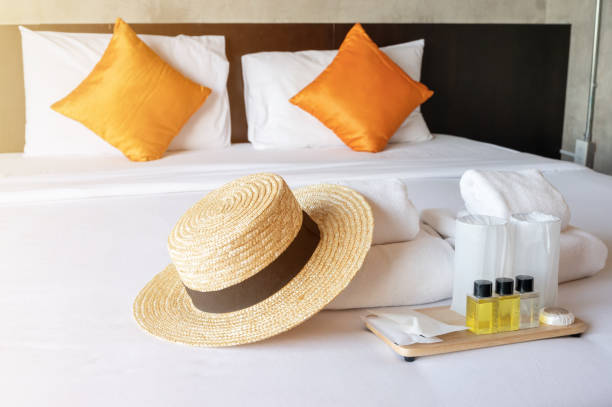 istock Set of hotel amenities (such as towels, shampoo, soap etc.) on the bed. 1308530127