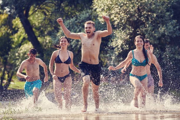 istock group of happy friends having fun on river 1308531619