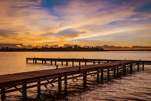 Wooden pier on Lake Paranoa under the beautiful sky of Brasilia at sunset time