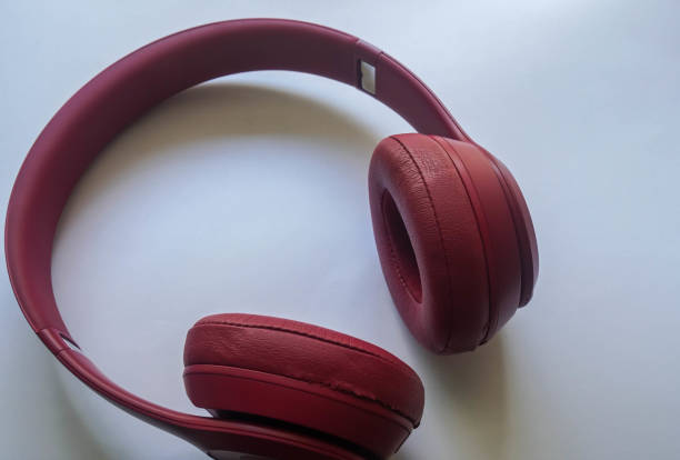 istock isolated selective focus women pink foldable bluetooth headphone 1308534321
