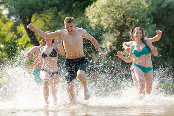 istock group of happy friends having fun on river 1308535294