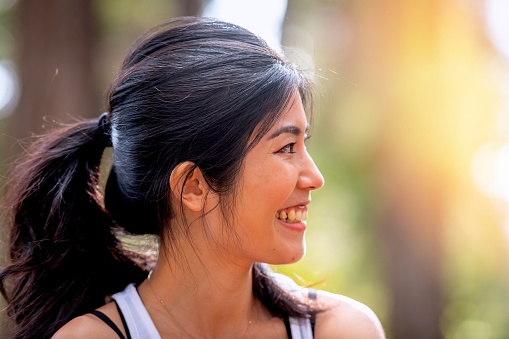Smiling beautiful mid adult asian woman looking away