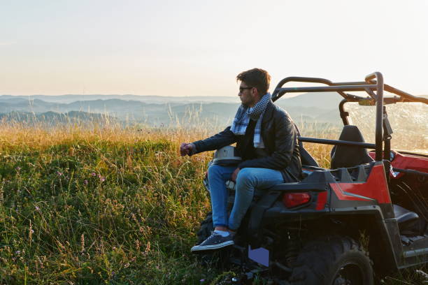 istock man enjoying beautiful sunny day while driving a off road buggy car 1308535973