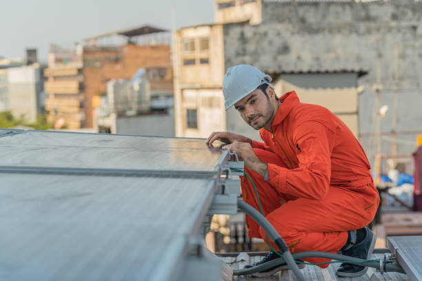 istock caucasian service and maintenance engineer for solar rooftop system checking energy performance of solar cell panels installed on plant rooftop 1308536229