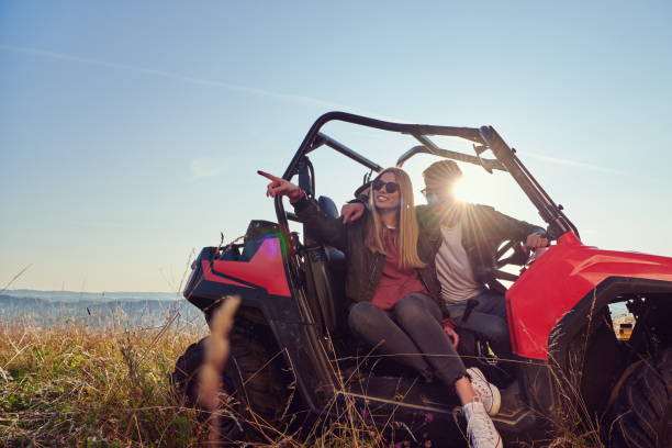 istock couple enjoying beautiful sunny day while driving a off road buggy 1308537983