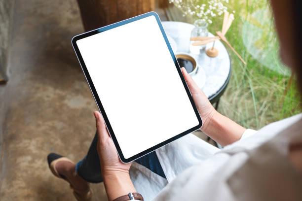istock a woman holding digital tablet with blank white desktop screen in cafe 1308540683