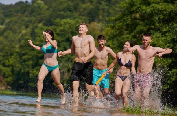 istock group of happy friends having fun on river 1308543771