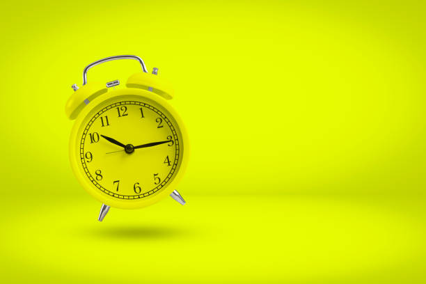istock Yellow alarm clock isolated on yellow background with copy space. 1308546809